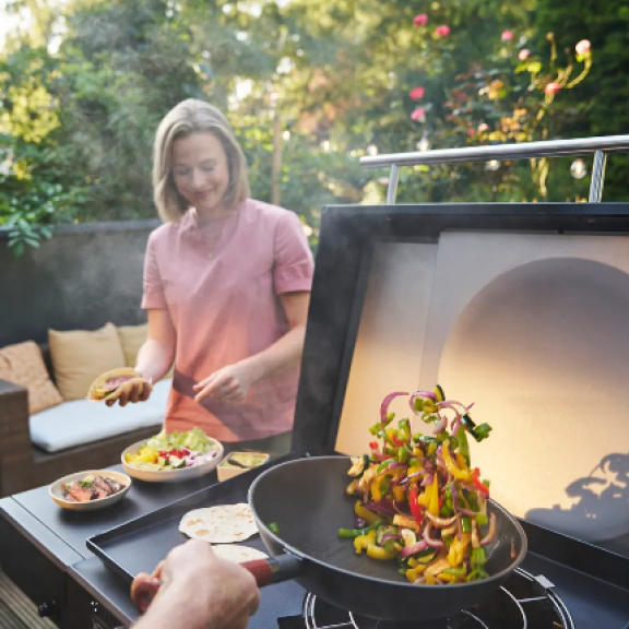Char-Broil Gear Trax condiment basket attached to a gas grill side shelf